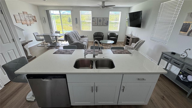 kitchen featuring white cabinetry, a center island with sink, sink, and stainless steel dishwasher