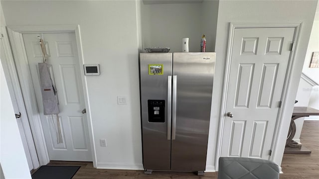 kitchen featuring stainless steel fridge and hardwood / wood-style flooring