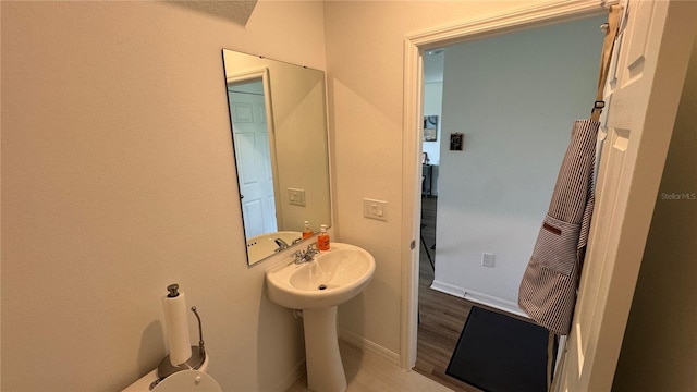 bathroom with wood-type flooring