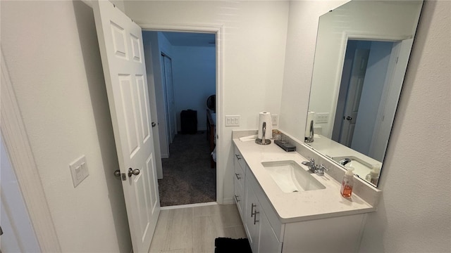 bathroom with hardwood / wood-style floors and vanity