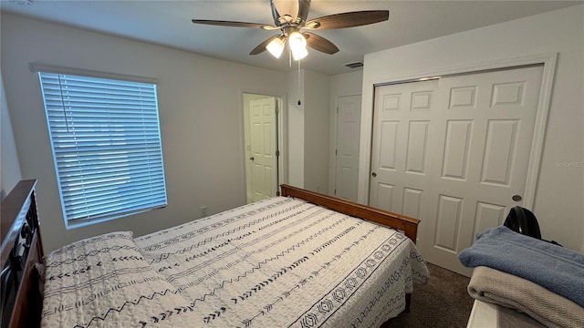 carpeted bedroom with a closet and ceiling fan