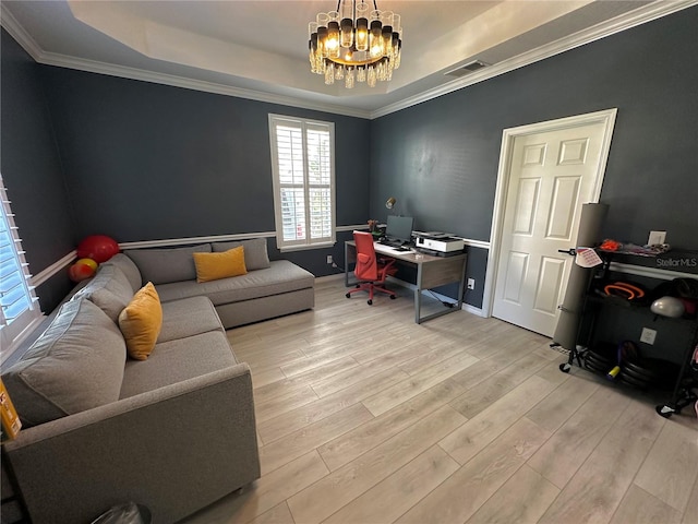 home office featuring an inviting chandelier, light hardwood / wood-style flooring, ornamental molding, and a tray ceiling