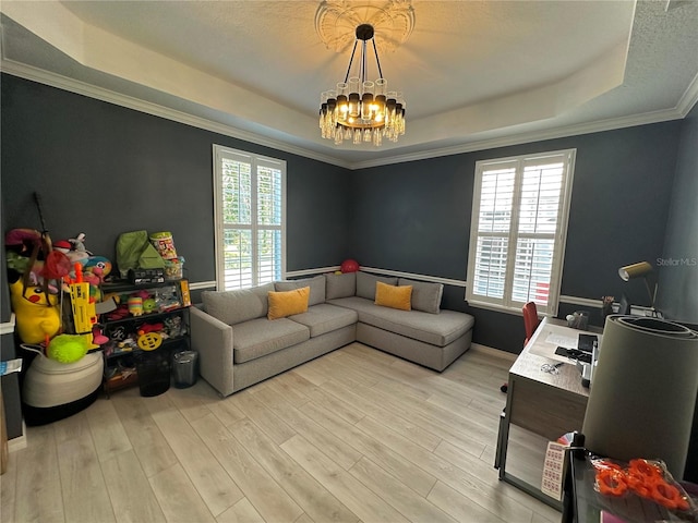 living room with ornamental molding, light hardwood / wood-style floors, a tray ceiling, and plenty of natural light