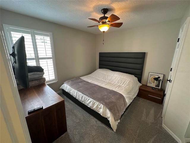 carpeted bedroom with ceiling fan and a textured ceiling