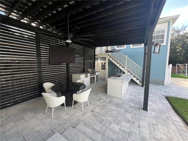 view of patio / terrace with ceiling fan, area for grilling, and an outdoor kitchen