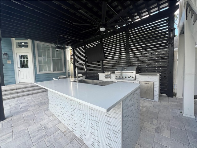 view of patio featuring ceiling fan, area for grilling, grilling area, and an outdoor bar