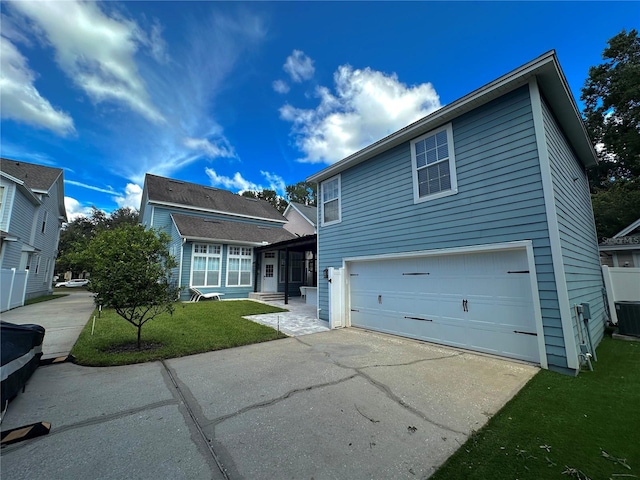 view of front of property with a garage and a front lawn