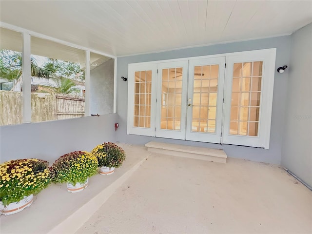 view of exterior entry with a patio and french doors