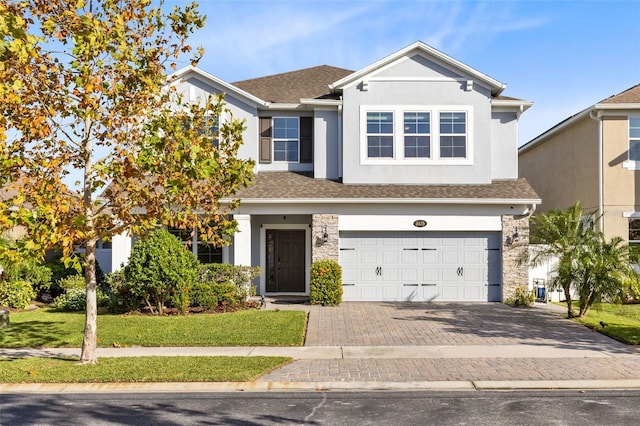 view of front facade featuring a front lawn and a garage