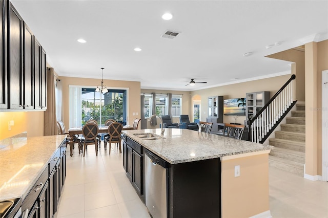 kitchen featuring sink, light stone counters, decorative light fixtures, a kitchen island with sink, and dishwasher