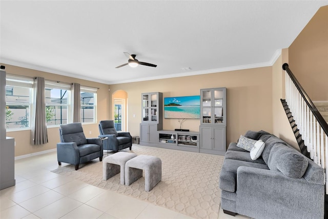 tiled living room featuring ceiling fan and ornamental molding