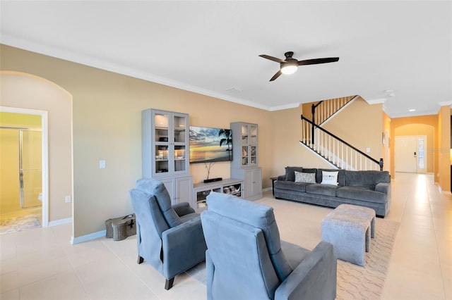 tiled living room featuring ceiling fan and ornamental molding