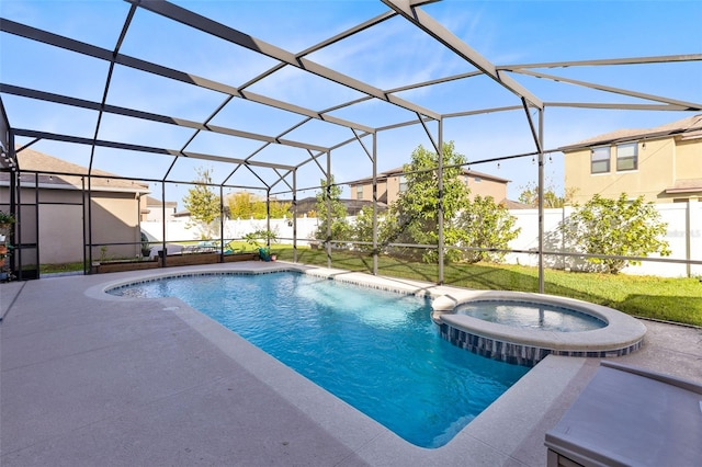 view of pool featuring glass enclosure, a patio, and an in ground hot tub