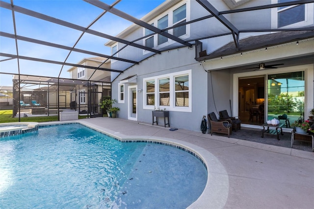 view of pool featuring a lanai, ceiling fan, and a patio