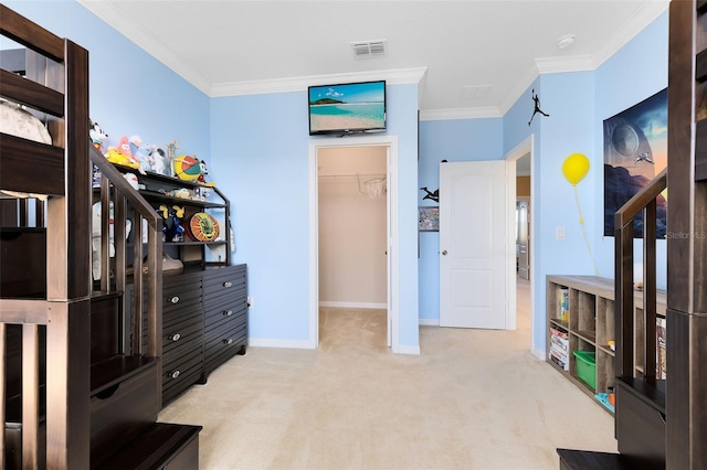 bedroom featuring a walk in closet, light colored carpet, a closet, and crown molding