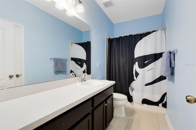 bathroom with tile patterned flooring, vanity, and toilet