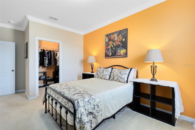 carpeted bedroom featuring ornamental molding, a walk in closet, and a closet