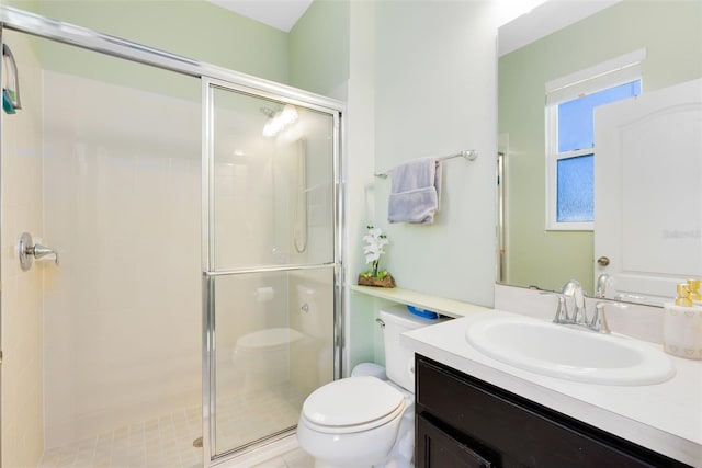 bathroom with an enclosed shower, vanity, and toilet