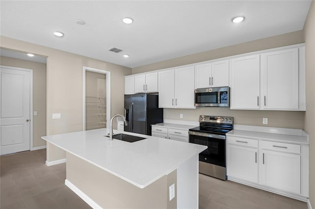 kitchen with a kitchen island with sink, sink, white cabinetry, and stainless steel appliances