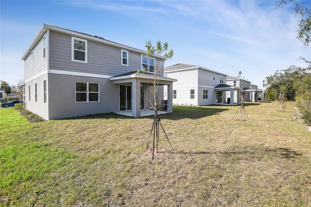 rear view of house featuring a lawn