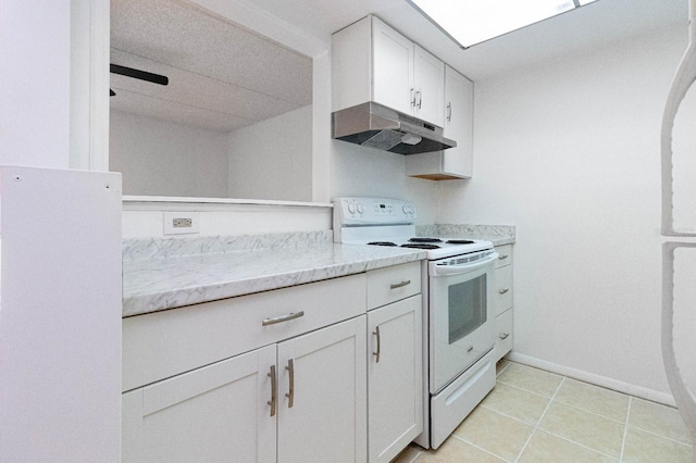 kitchen featuring white cabinets, light tile patterned floors, and white range with electric stovetop