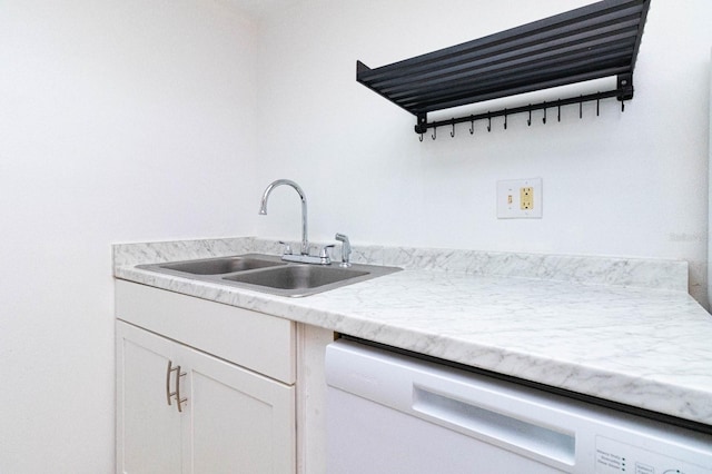 kitchen featuring sink, white dishwasher, and white cabinets