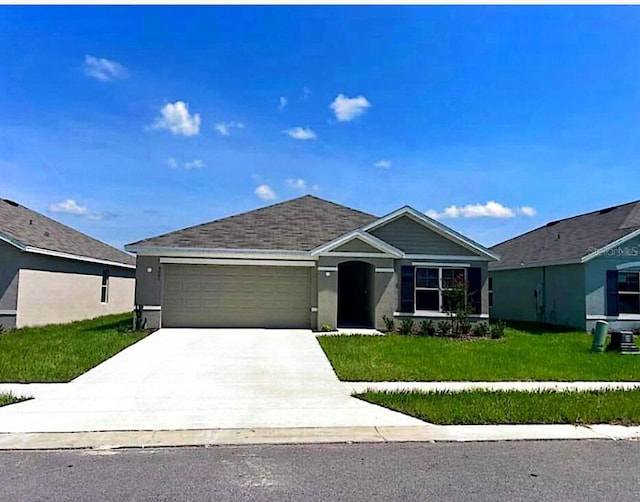 ranch-style house featuring a front lawn and a garage