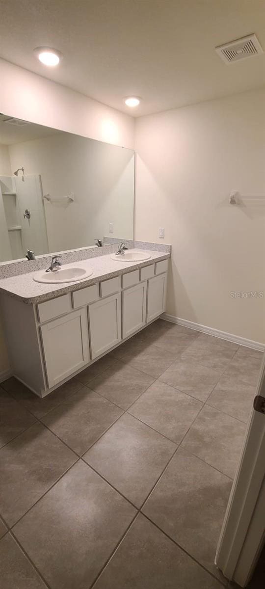 bathroom featuring tile patterned flooring and vanity