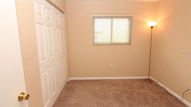 unfurnished bedroom with a closet and carpet floors