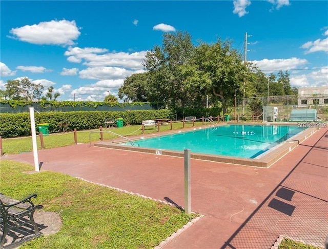 view of pool featuring a yard