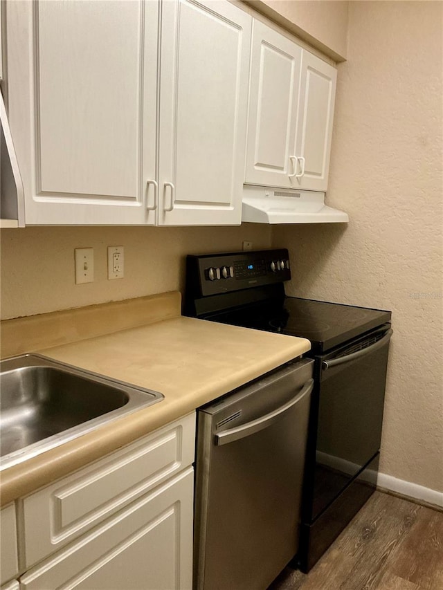 kitchen featuring white cabinets, appliances with stainless steel finishes, sink, and hardwood / wood-style floors