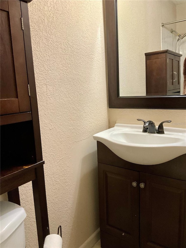 bathroom featuring vanity and toilet