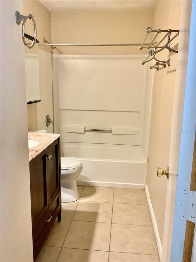 full bathroom featuring vanity, bathing tub / shower combination, toilet, and tile patterned flooring