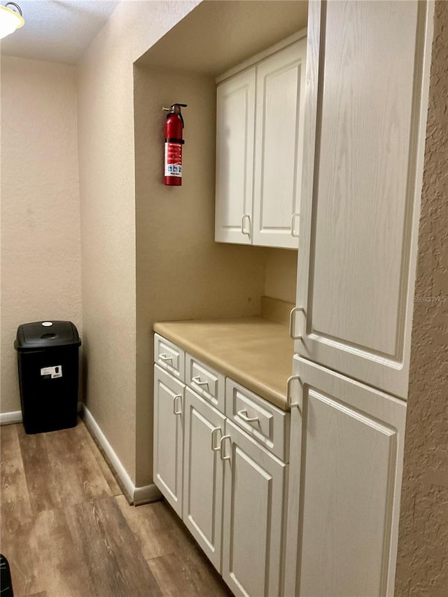 laundry room featuring light wood-type flooring