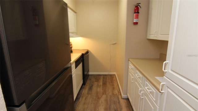 kitchen featuring white cabinetry, refrigerator, and dark hardwood / wood-style flooring