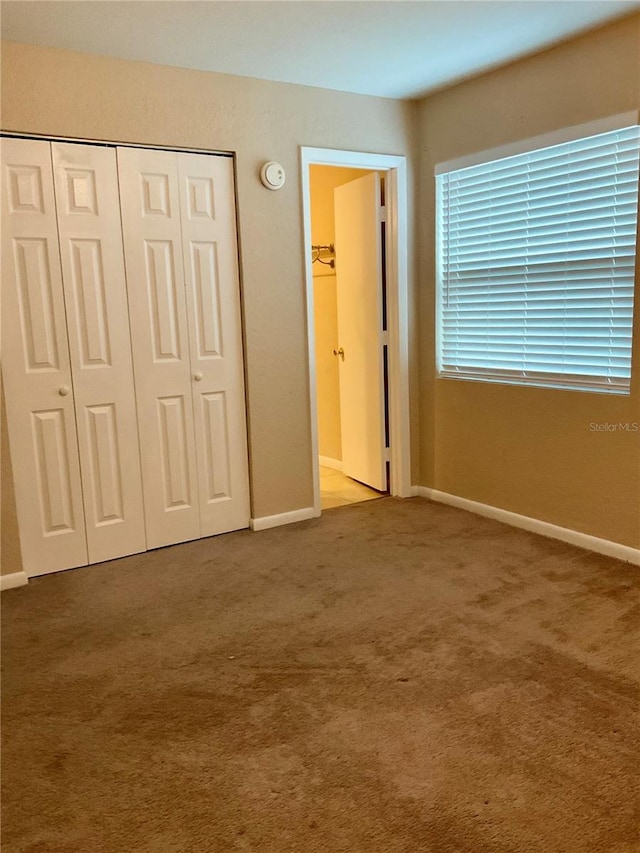 unfurnished bedroom featuring a closet and carpet