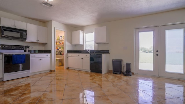 kitchen featuring white cabinets, light tile patterned floors, french doors, a textured ceiling, and black appliances