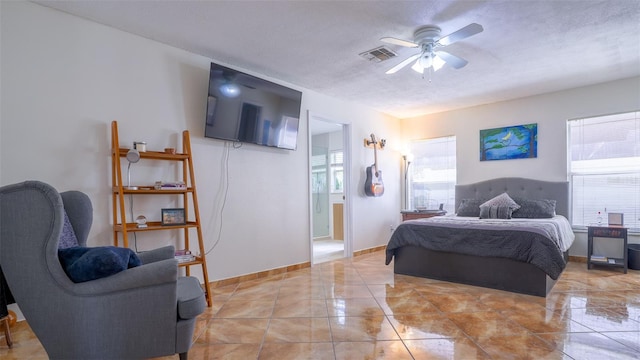 bedroom with ceiling fan, a textured ceiling, and multiple windows