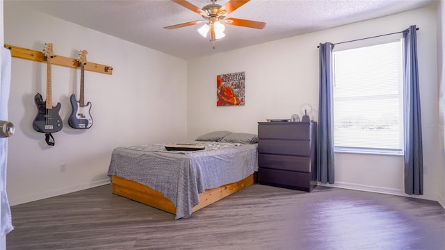 bedroom featuring ceiling fan, a textured ceiling, and hardwood / wood-style floors