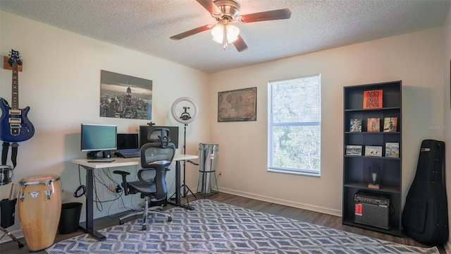 home office featuring a textured ceiling, dark hardwood / wood-style flooring, and ceiling fan