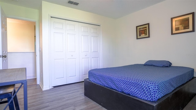 bedroom with a closet and hardwood / wood-style flooring