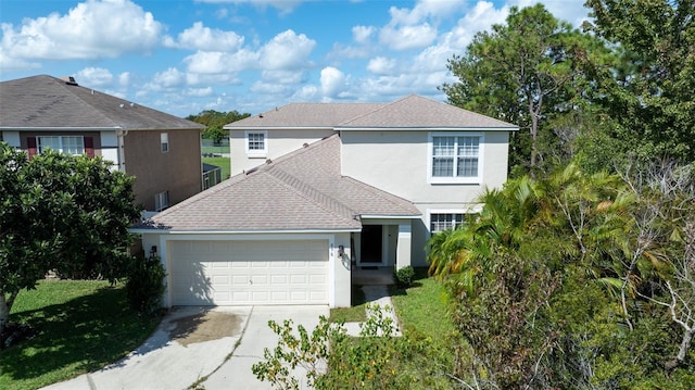 view of front of property featuring a garage and a front lawn