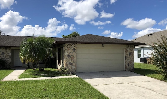 single story home featuring a front yard and a garage