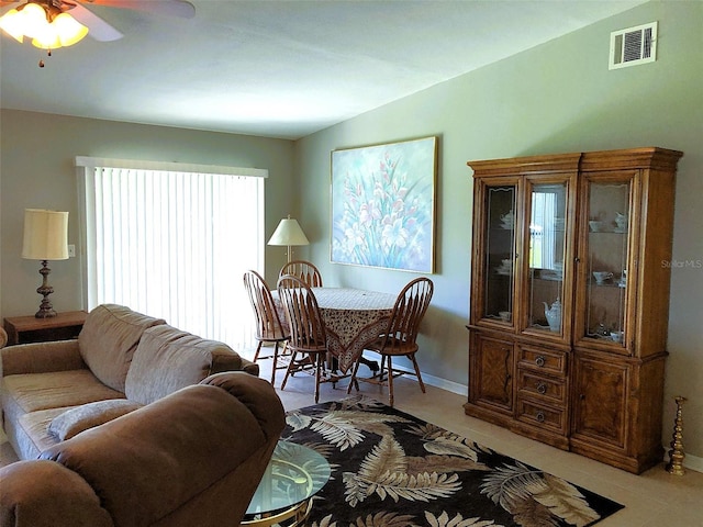 tiled living room with ceiling fan