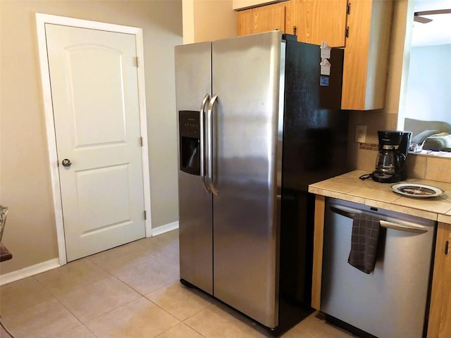 kitchen with stainless steel appliances and light tile patterned floors