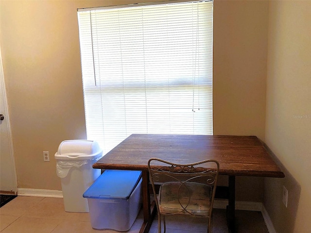 dining area featuring light tile patterned flooring and plenty of natural light