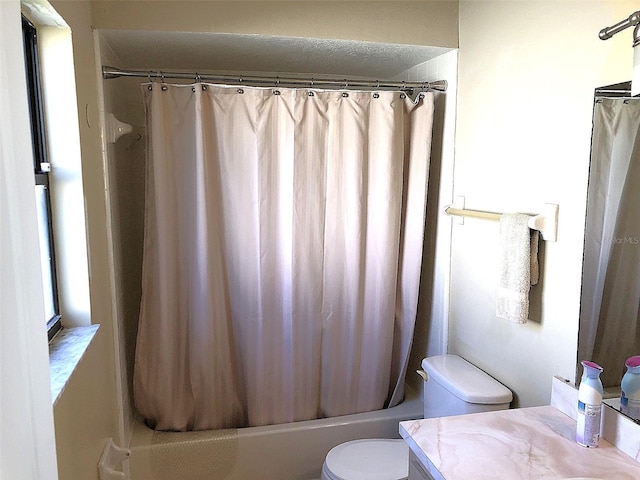 full bathroom featuring vanity, shower / tub combo with curtain, and toilet