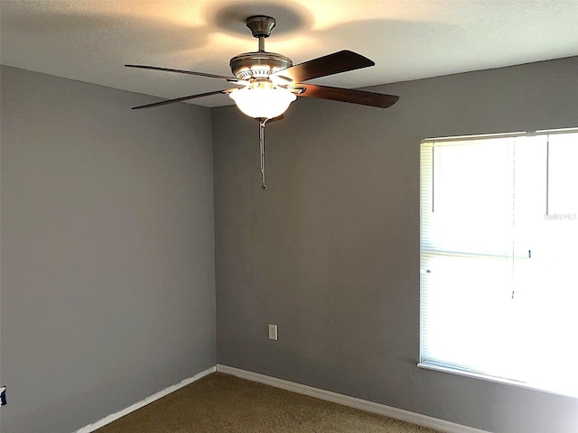 unfurnished room with carpet flooring and ceiling fan