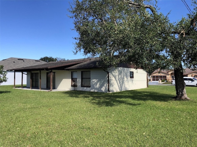 view of side of property with a yard