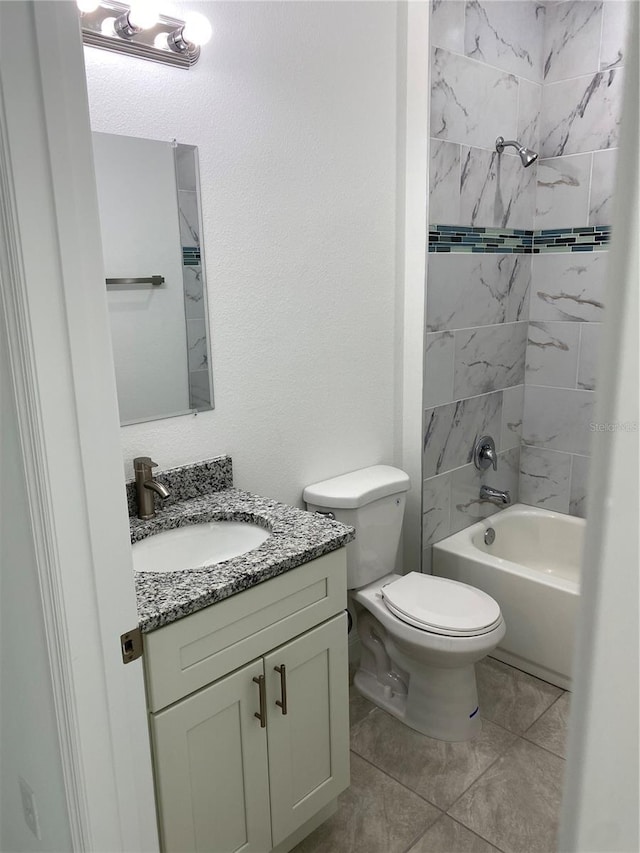 full bathroom with toilet, vanity, tiled shower / bath, and tile patterned flooring